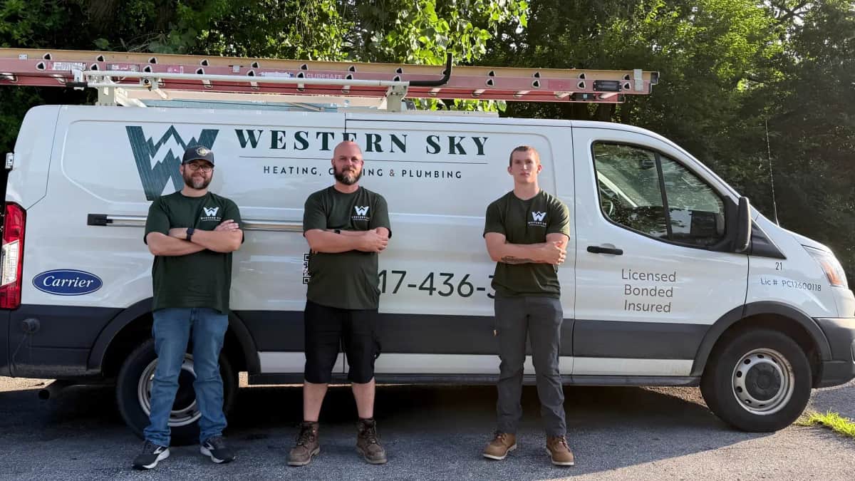 Three Western Sky technicians standing in front of a branded Western Sky service van in Fishers, Indiana.